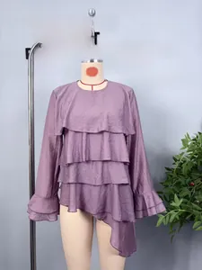 Detail view of purple chiffon top featuring layered ruffles and textured fabric design