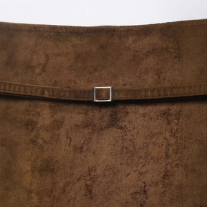 Brown faux suede mini skirt with a thin waist belt and a rectangular silver metal buckle