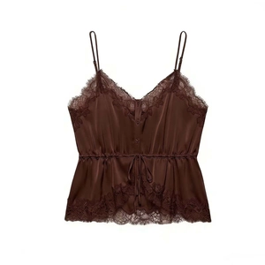 Detailed view of dark brown silk camisole featuring lace trim and button-front design