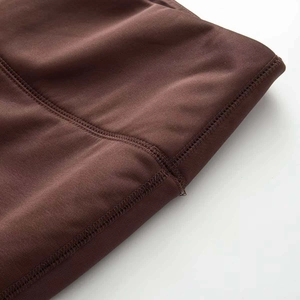 Detailed close-up of dark brown yoga set featuring durable four-needle six-thread stitching