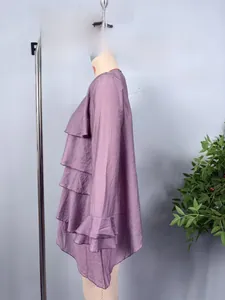 Detail of purple chiffon top featuring layered asymmetric ruffles and ruched cuffs