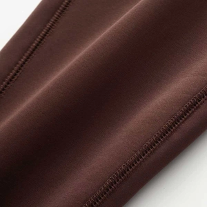 Close-up of high-elasticity chocolate brown yoga fabric with flatlock four-needle six-thread stitching