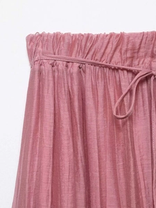 Detailed view of pink linen skirt with elastic pleated waistband and matching drawstring tie
