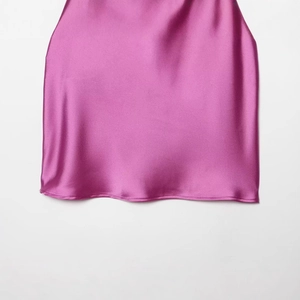 Women's fuchsia satin halter top featuring a luxurious silky glossy finish and smooth hem