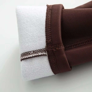 Close-up of deep brown knit fabric with thick white fleece lining and neat stitching