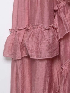 Detail shot of dusty pink tiered ruffles and textured fabric on a stylish skirt