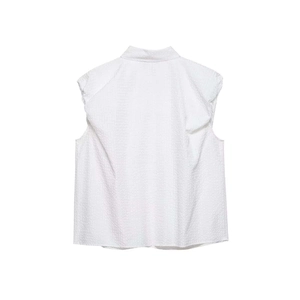 Detailed back view of sleeveless white blouse with ruffled shoulders and textured fabric