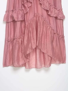 Detailed view of dusty pink tiered ruffles on a high-low irregular hemline skirt