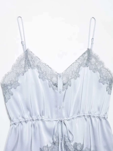 Detail of light blue satin camisole with delicate grey lace trim and V-neckline