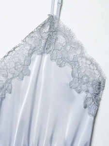 Close-up of light blue satin top featuring intricate eyelash lace trim at the V-neckline