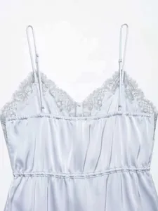 Detail of light blue satin camisole featuring delicate lace trim and adjustable straps