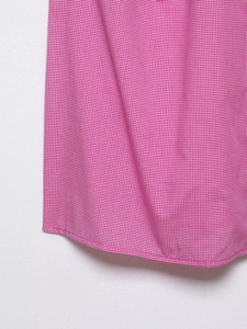 Detailed close-up showing pink and white gingham fabric texture and precise hem stitching