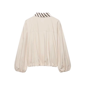 Detail view of beige striped jacket back with elastic cuffs and contrasting collar