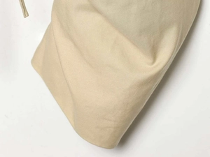 Detailed macro view showing the twill fabric texture and drawstring on apricot jacket