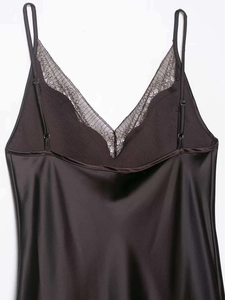 Detail of V-neckline featuring delicate black lace trim and adjustable spaghetti straps