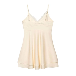 Detail of white satin nightgown with delicate lace V-neckline and adjustable straps