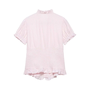 Detail of pink striped shirt showing smocked waist and delicate ruffle trim texture