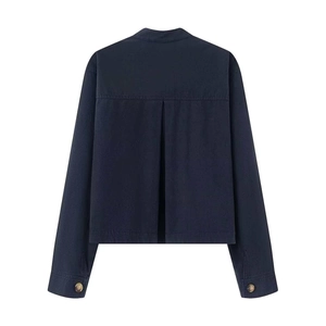 Detail view of the pleated back design on a navy blue short denim jacket