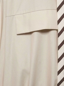 Detail of a beige striped shirt with a clean flap pocket and high-quality cotton fabric
