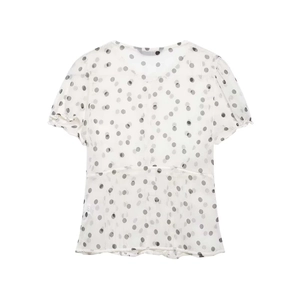Detail of white chiffon blouse featuring black polka dots and pleated puff sleeves
