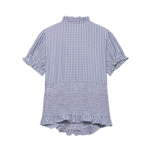 Detail of blue and white gingham blouse with smocked waist and ruffle trim detailing