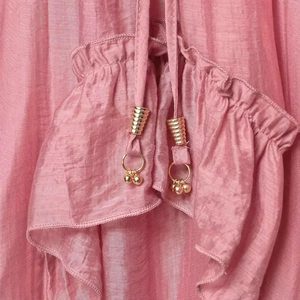 Pink satin skirt with elegant ruffled edge and golden metal drawstring pendants