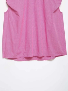 Close-up detail of pink and white gingham fabric on a casual sleeveless summer top