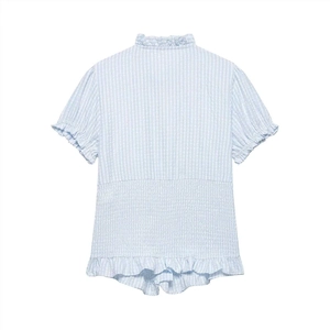 Detail of smocking waist and ruffle trim on blue white striped short sleeve blouse