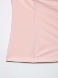 Detail of pink satin top with delicate stitching and smooth breathable fabric texture