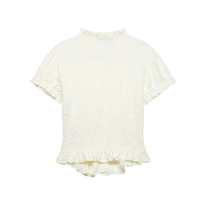 Detail of smocked waist and ruffled hem on a beige short-sleeved textured shirt