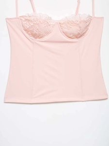 Detailed view of pale pink camisole with delicate lace cups and structured stitching