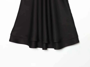Close-up of the elegant double-layered hemline on this black satin V-neck nightgown