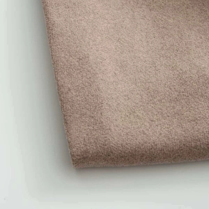 Close-up of premium light camel wool fabric texture on long coat with soft finish