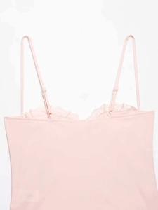 Close-up of pink satin camisole featuring delicate lace trim and adjustable straps