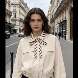 Elegant beige long sleeve blouse with striped bow tie collar in a chic street style