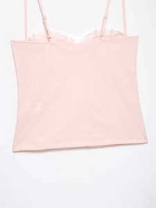 Detail view of pink satin camisole showing adjustable straps and delicate lace trim