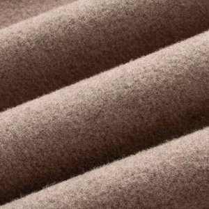 Close-up of premium camel wool fabric with dense texture and soft tactile feel