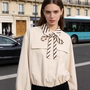 Elegant beige long sleeve blouse with brown striped bow tie and flap pockets