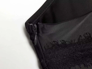 Detail view of high-quality invisible zipper and floral lace trim on black satin sleepwear