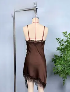 Detail of coffee satin slip dress featuring back V-neck and black lace trim on a mannequin