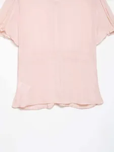 Detail of pink chiffon top featuring high-waisted stitching and soft flared hemline