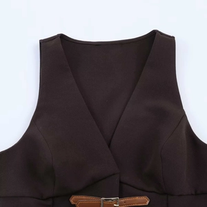 Gros plan détaillé de la taille d'un gilet marron avec fine ceinture et boucle en argent