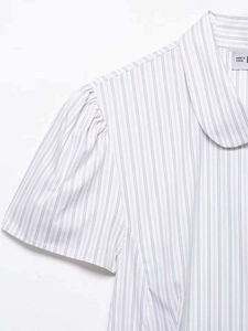 Detail of blue striped poplin shirt featuring a Peter Pan collar and puff sleeves