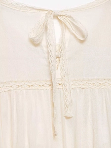 Detail of apricot lace patchwork and drawstring on lightweight chiffon blouse for women