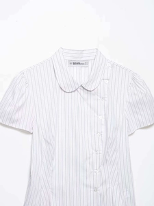 Detail of blue striped poplin shirt with Peter Pan collar and side button closure