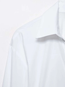 Detailed close-up of premium white shirt collar with fine stitching and cotton texture