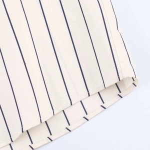 Detail of blue vertical stripes on breathable cotton fabric with curved hem stitching