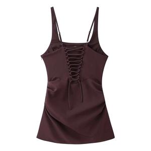 Detail view of burgundy slip dress featuring criss-cross lace-up back and thin straps