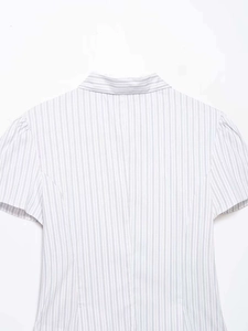 Detail view of the back seams and blue striped poplin fabric on a short sleeve shirt