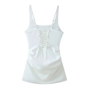 Detailed back view of white lace-up mini dress with slim straps and ruched side accents